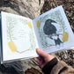 two inside pages of the book are shown, on the left the text reads "I am a currawong, with a yellow eye" on the right there is an illustrated picture of a currawong sitting on a branch.  each page has a border of native Australian flowers