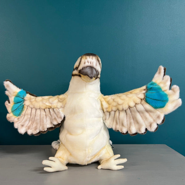 plush kookaburra puppet faces the camera with wings outstretched