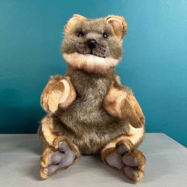 A soft plush brown Quokka puppet in a seated position