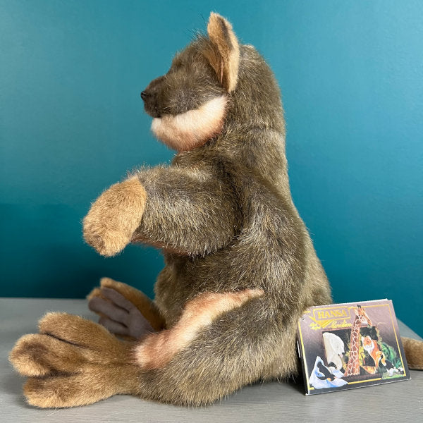 side view of brown quokka puppet, the Hansa Creations tag is visible